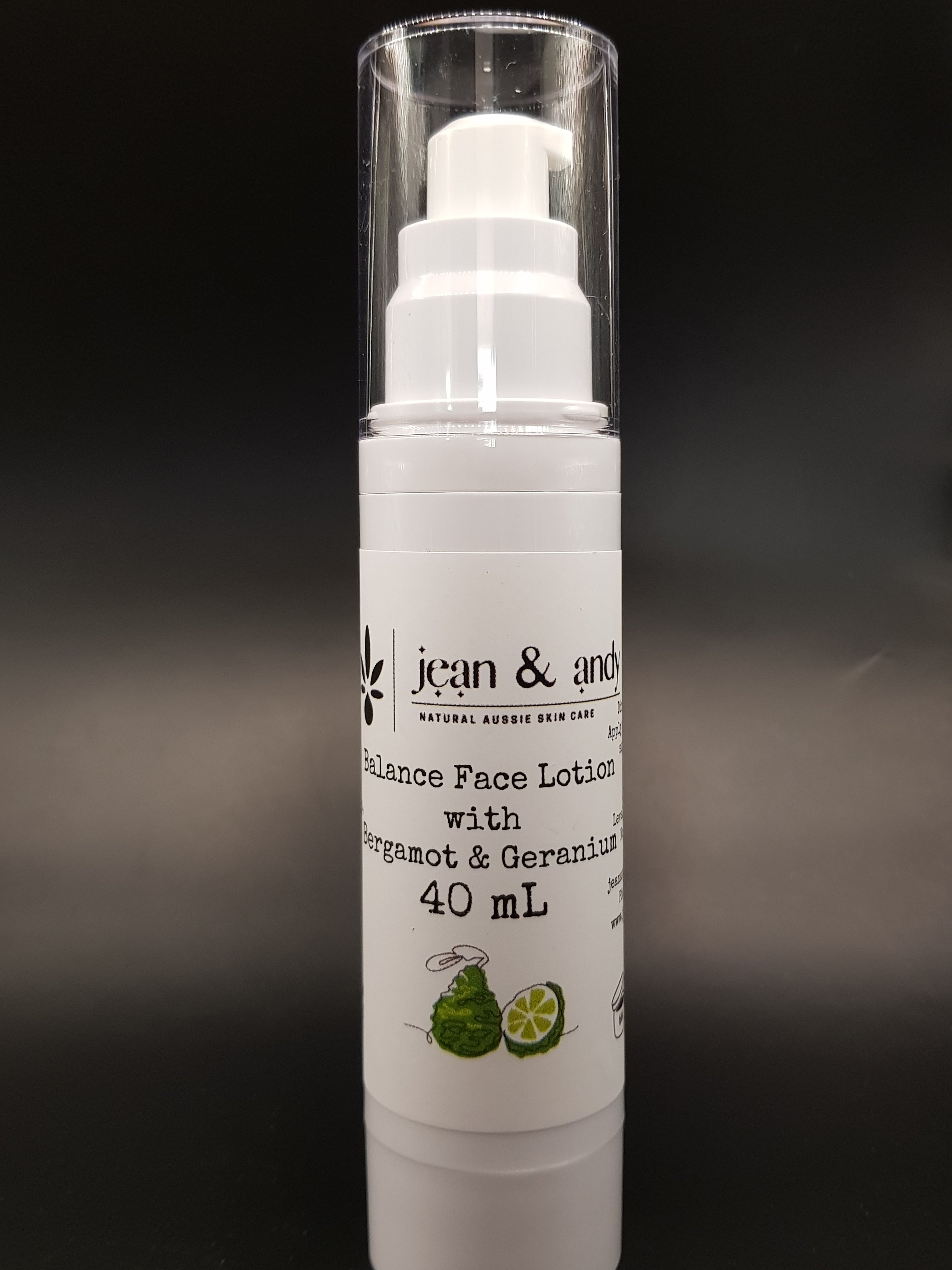 The Bergamot Balancing Face Lotion by jean & andy comes in a clear bottle featuring a pump dispenser. The label, designed with a dark background, includes illustrations of bergamot and geranium and prominently displays 40 mL along with "Natural Aussie Skincare," highlighting its enrichment with nourishing Jojoba Oil.